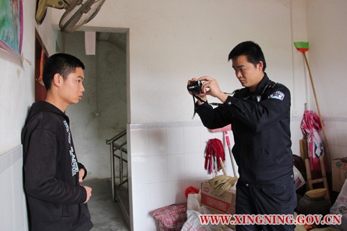 民警陈东海正在为巫某照相.jpg